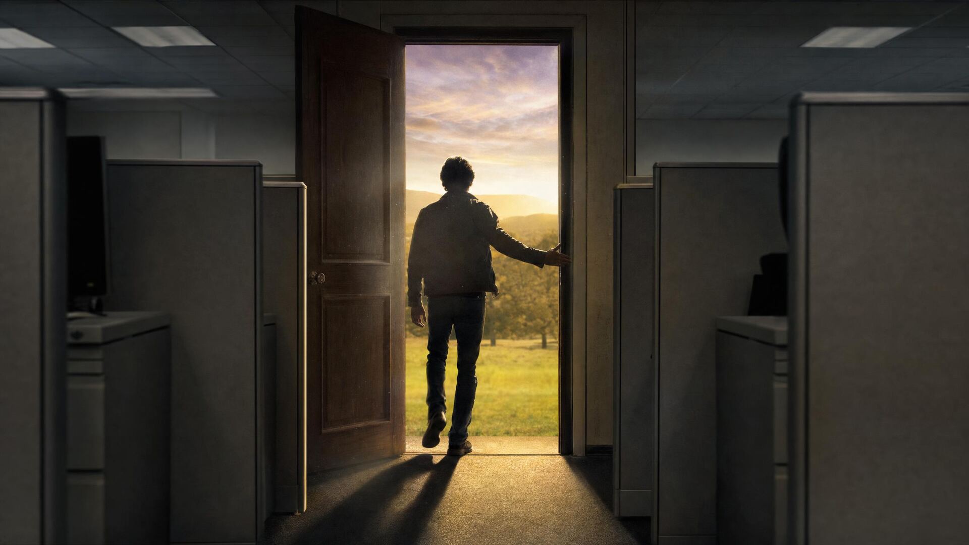 A person stepping out of a grey office into morning light